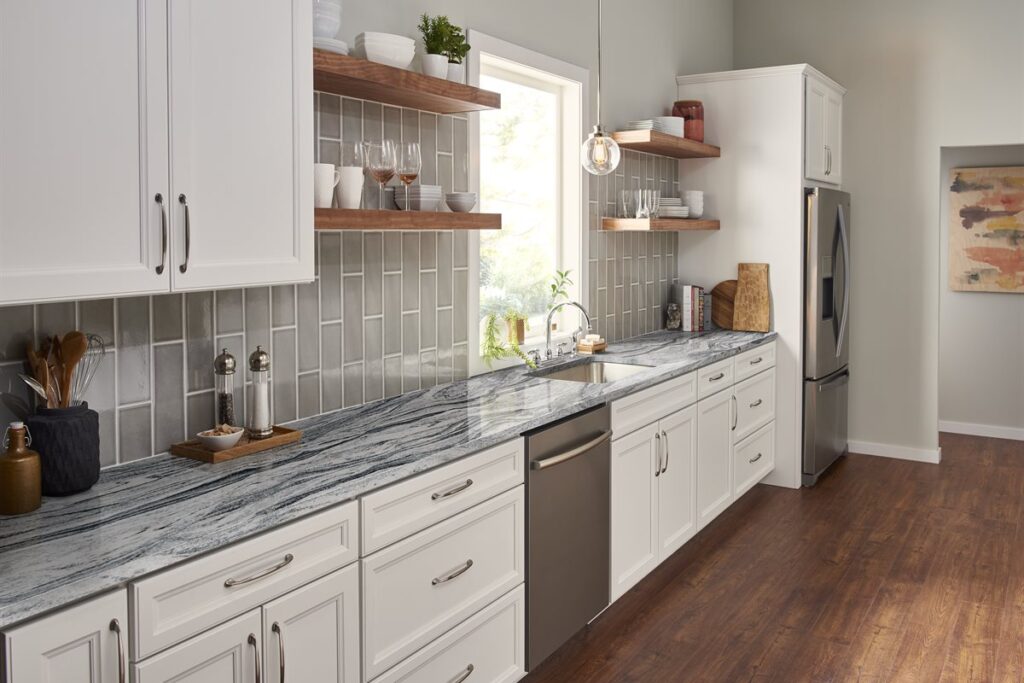 Kitchen with grey backsplash and marble countertop